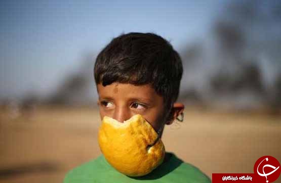 تصاویر روز: از تعمیر برج بیگ بن و پوشش یکپارچه سبز در مراسم یادبود وینی ماندلا تا مراسم آب بازی در سال نوی تایلندی