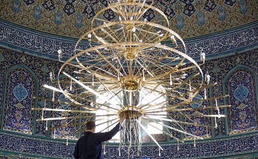 غبار روبی بزرگترین لوستر حرم حضرت معصومه(س) +تصاویر